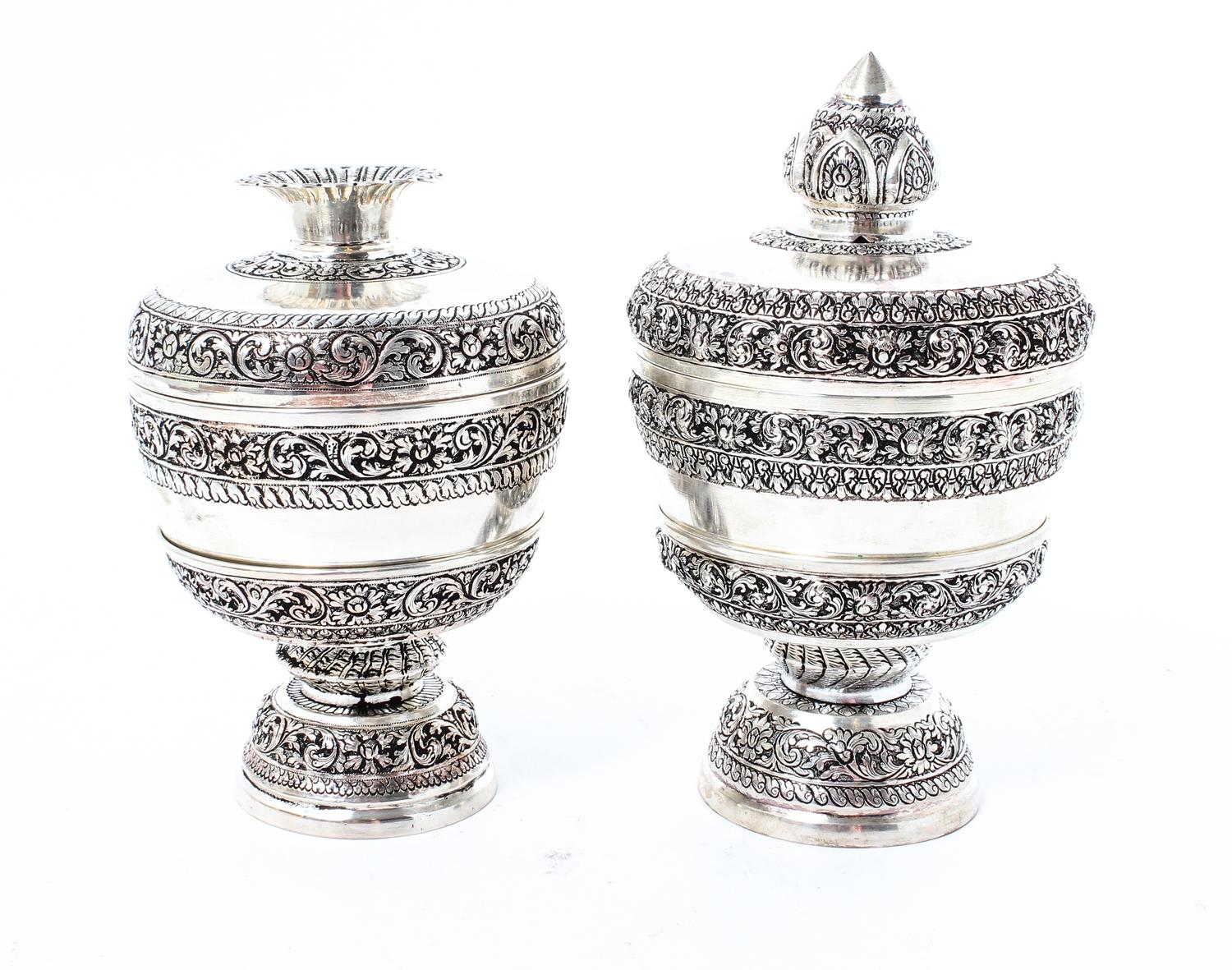 Two Silvered Metal Covered Cups on Stands, , each with alternating bands of scrolling decoration, each in a fitted box.