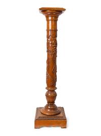 An Italian Carved Walnut Marble-Top Pedestal
