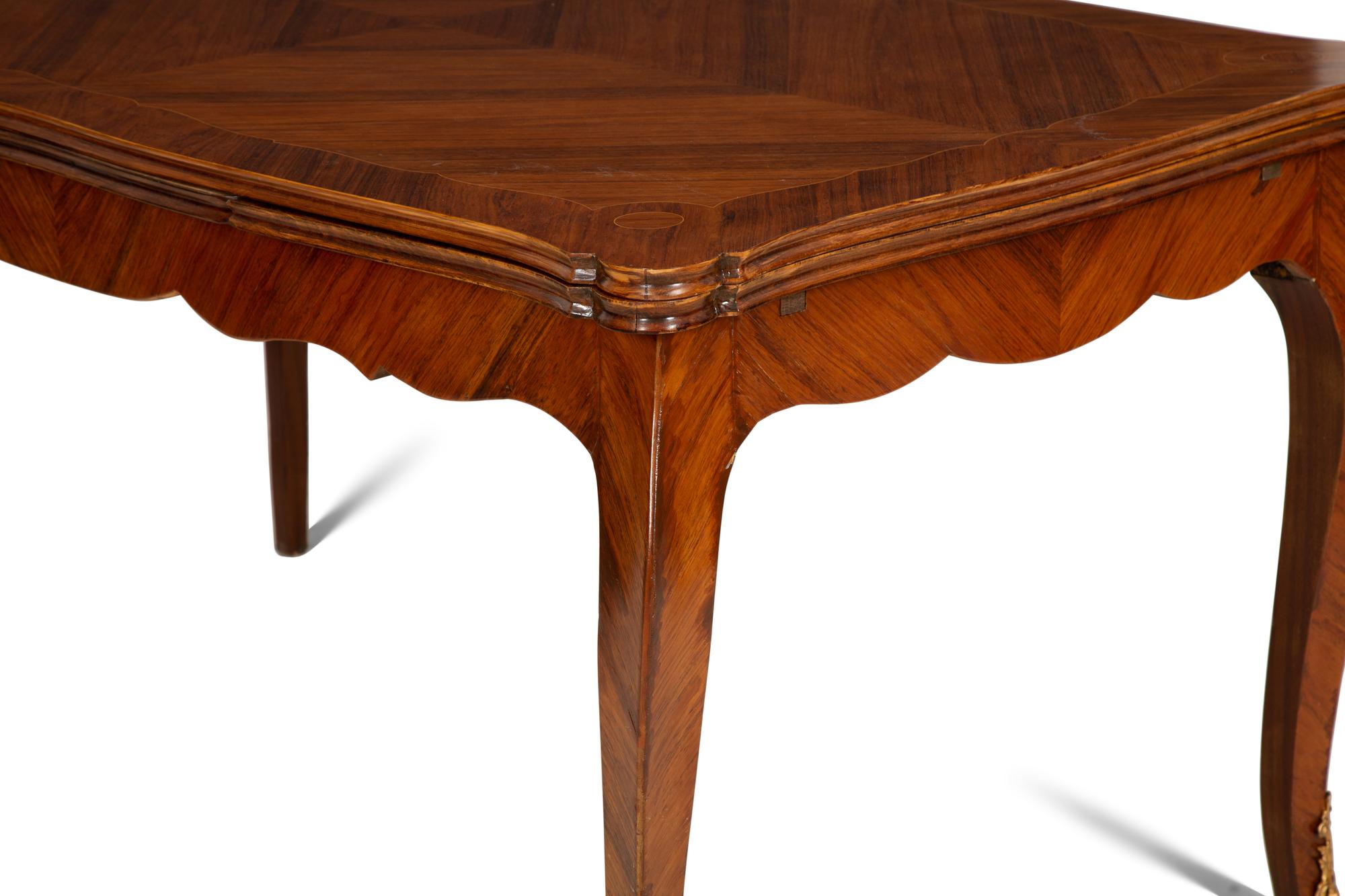 A Louis XV Style Gilt Bronze Mounted Tulipwood and Marquetry Extension Dining Table