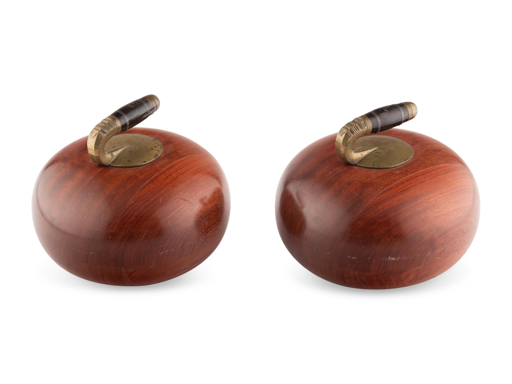 Two Metal Mounted Carved Wood Curling Stones