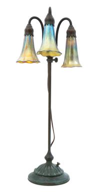 A Tiffany Studios Bronze and Favrile Glass Three-Light Lily Lamp Height 22 1/2 inches.