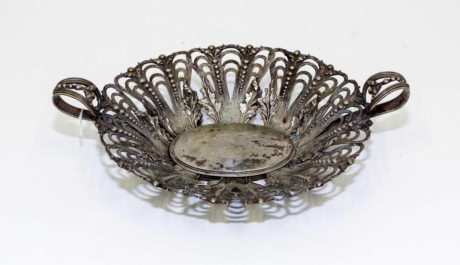 A Continental Silver Centerpiece Basket, , having open work decoration with foliate and bead motifs throughout.