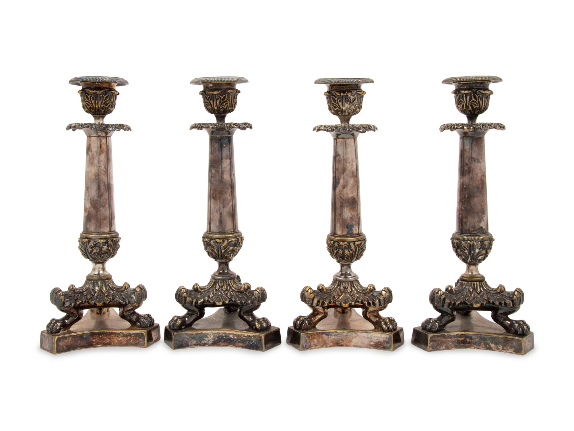 A Set of Four Neoclassical Silvered Bronze Candlesticks
