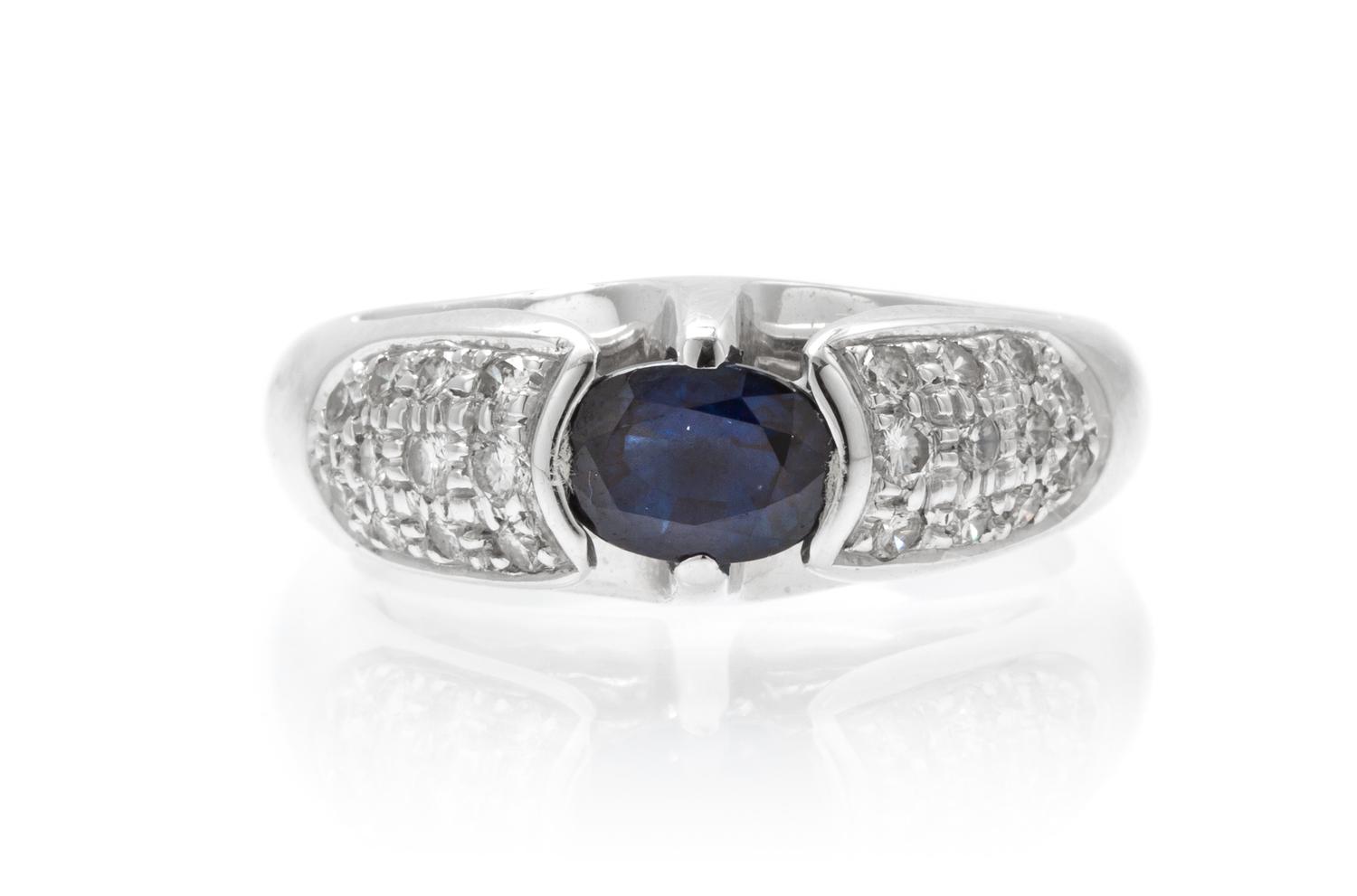 An 18 Karat White Gold, Sapphire and Diamond Ring, 6.50 dwts.