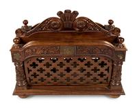 An Oversized Carved Walnut Canterbury