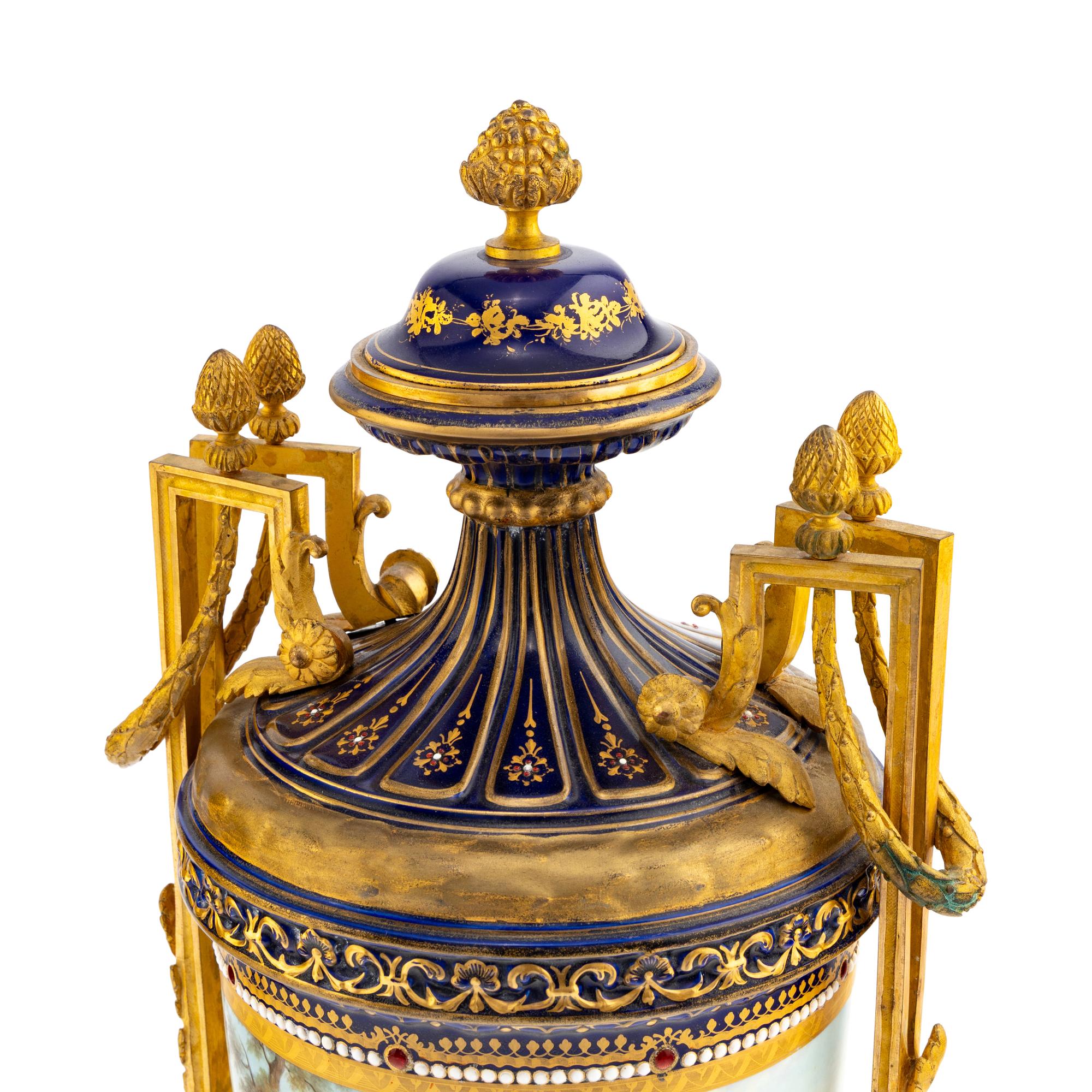 A Pair of Sèvres Style Gilt Bronze Mounted Porcelain Urns