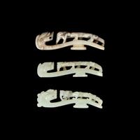 A Chinese 'Chicken-Bone' Jade and Two Pale Celadon Jade 'Dragon' Belt Hooks, Qing Dynasty 清 玉龍鉤三件