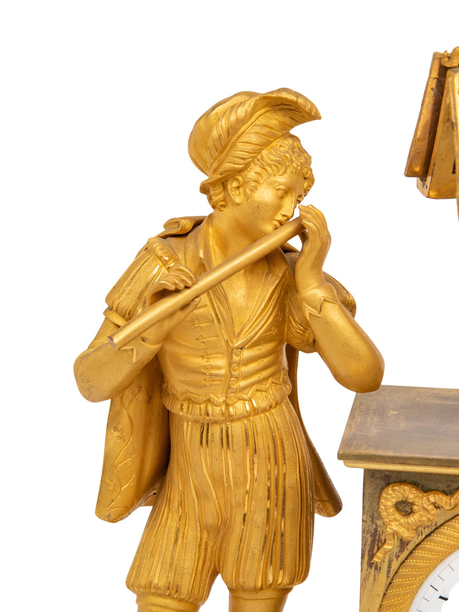 An Empire Gilt Bronze Figural Mantel Clock