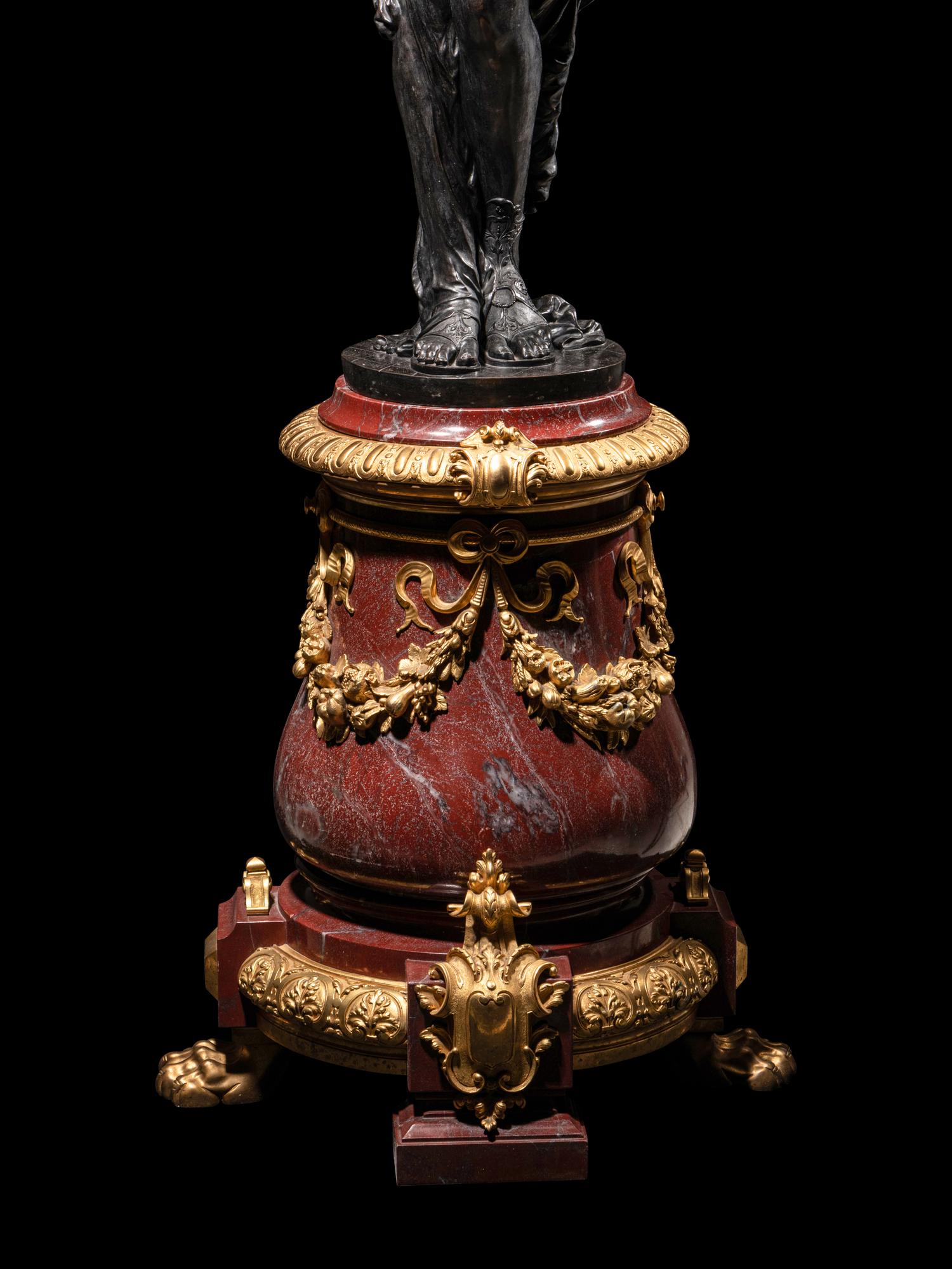 A Pair of Monumental Gilt and Patinated Bronze and Rouge Marble Figural Torchères