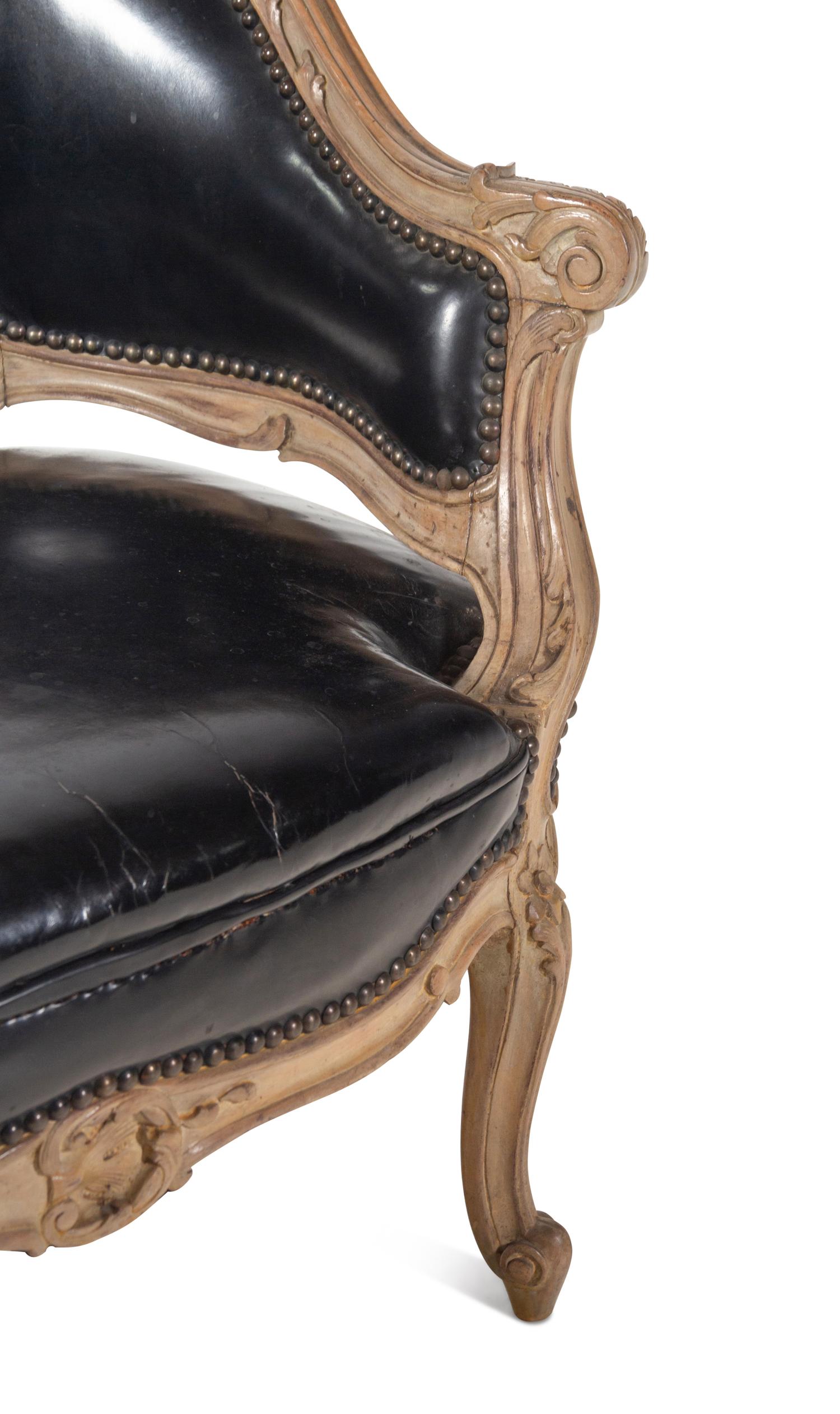 A Louis XV Style Painted and Black Leather Upholstered Bergère