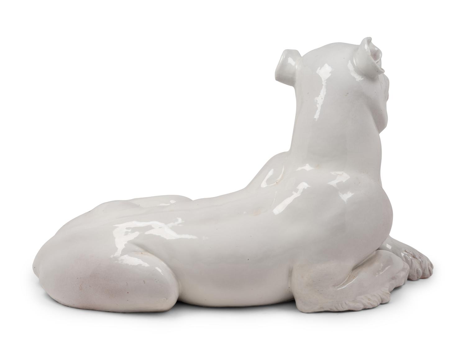 An Italian Painted Terra Cotta Figure of a Recumbent Dog