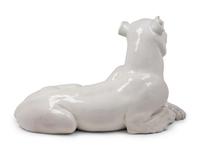 An Italian Painted Terra Cotta Figure of a Recumbent Dog