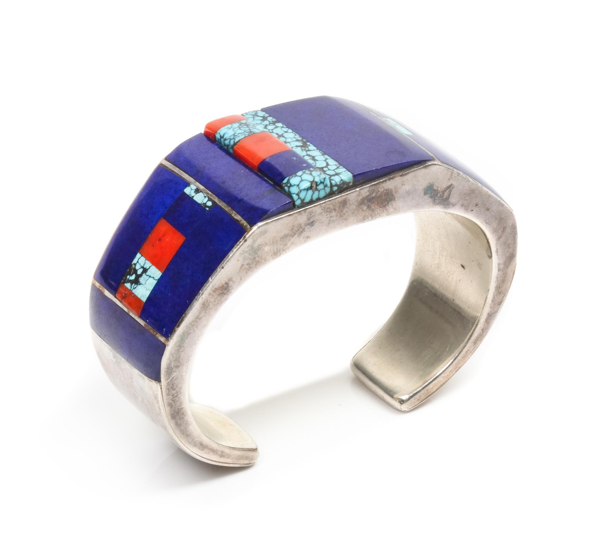 A Zuni Silver, Lapis, Turquoise and Coral Bracelet, Roger Tsabetsaye Length 4 7/8 x opening 7/8 x width 1 inches.
