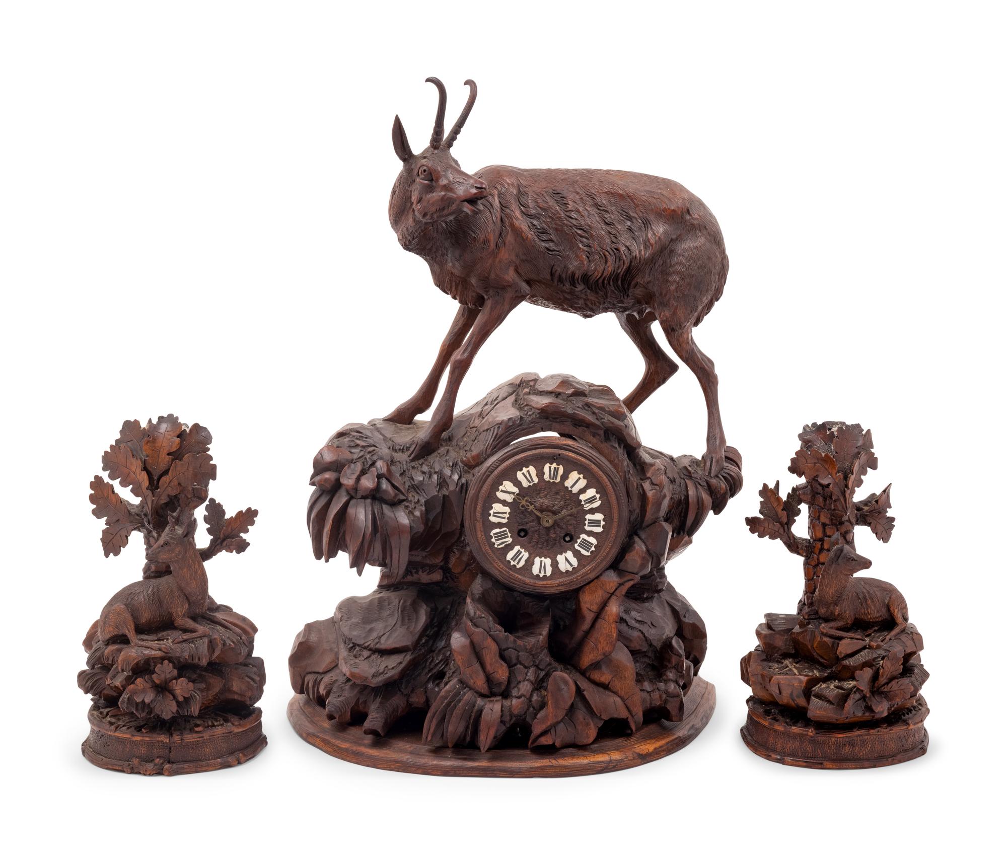 A Black Forest Carved Clock Garniture