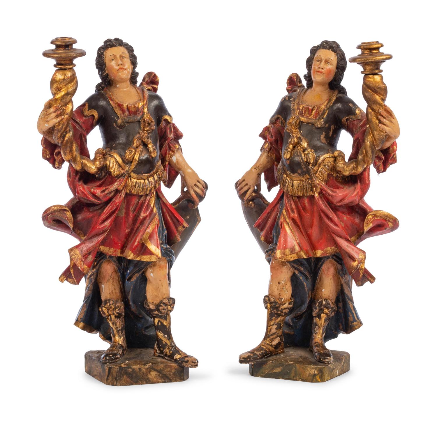 A Pair of Italian Carved and Polychrome Decorated Figural Candlesticks