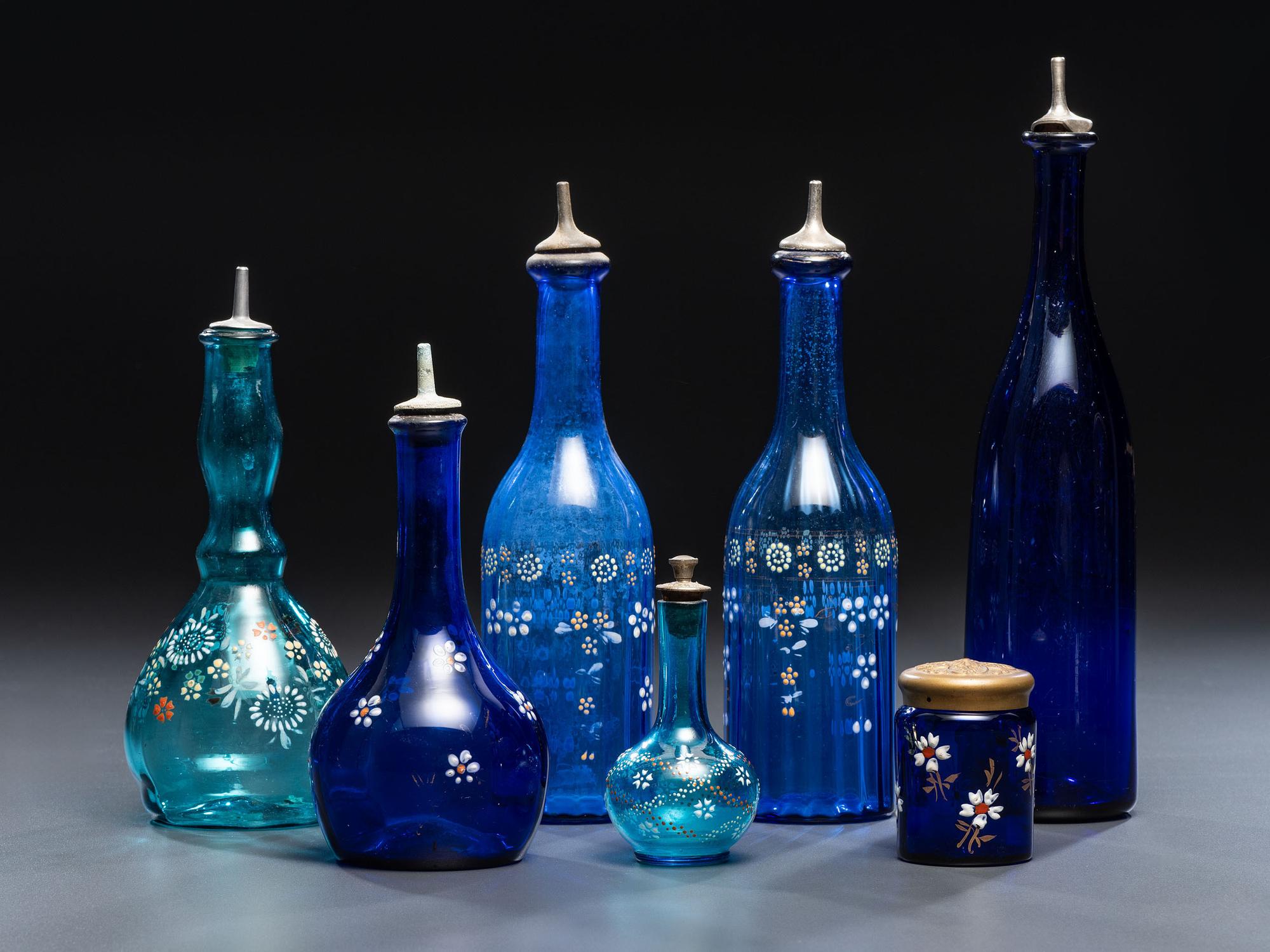 Seven Enameled Glass Barber Items