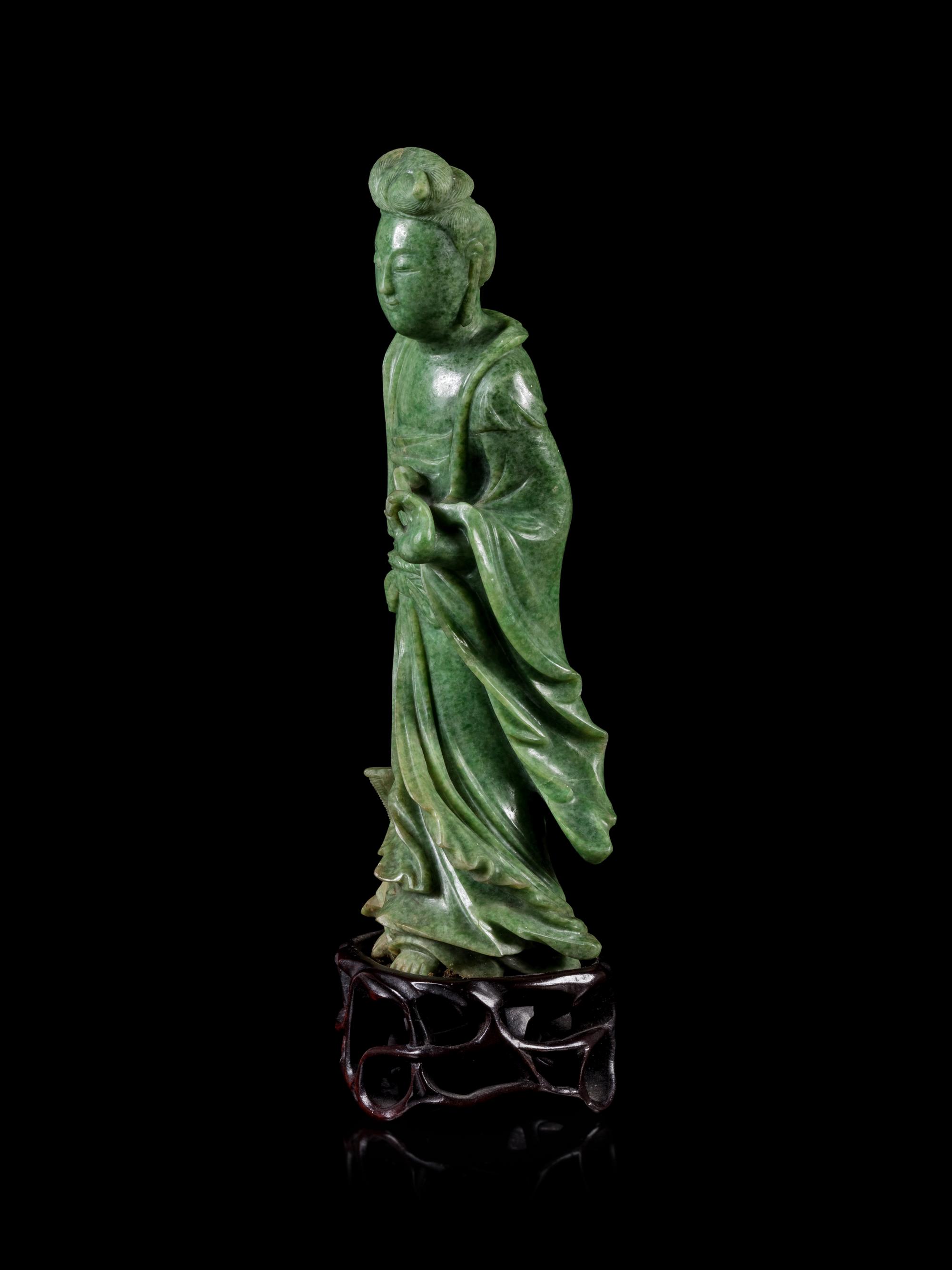 A Mottled Green Jade Figure of Guanyin