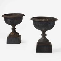 A pair of black-painted cast iron garden urns late 19th century