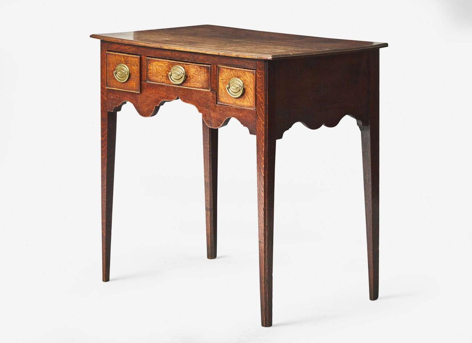 A George III provincial carved oak dressing table, late 18th century