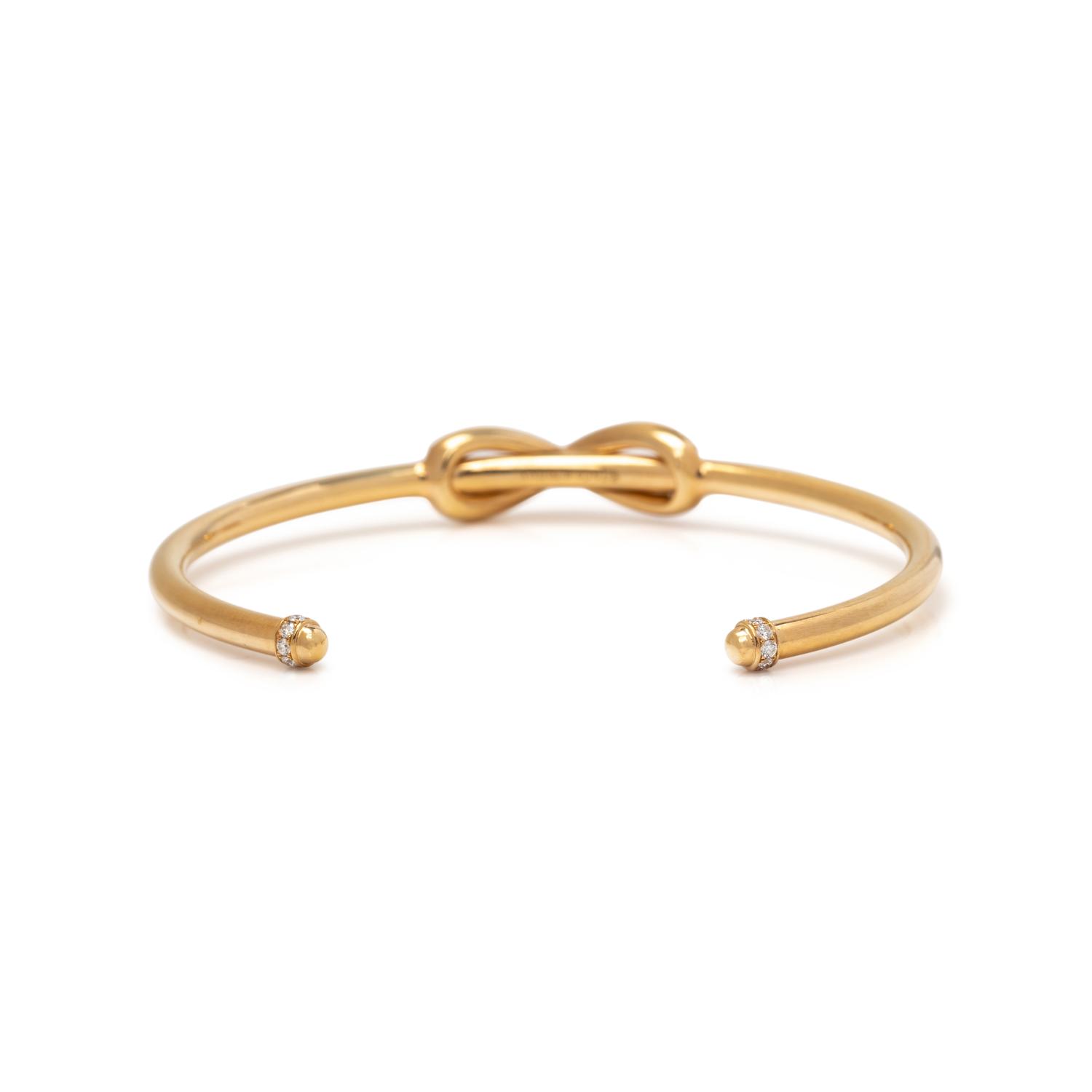 TIFFANY & CO., YELLOW GOLD AND DIAMOND 'INFINITY' CUFF BRACELET