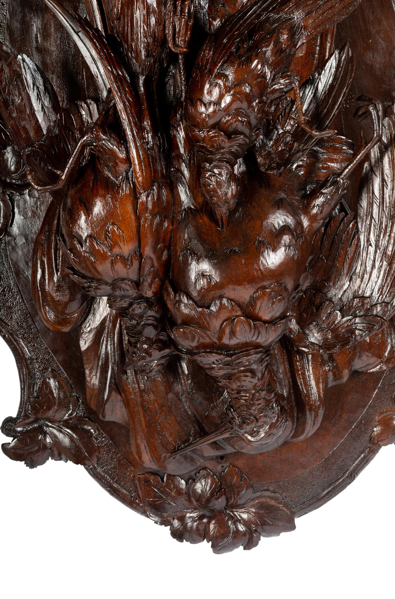 A Pair of Swiss Black Forest Carved Walnut Game Plaques