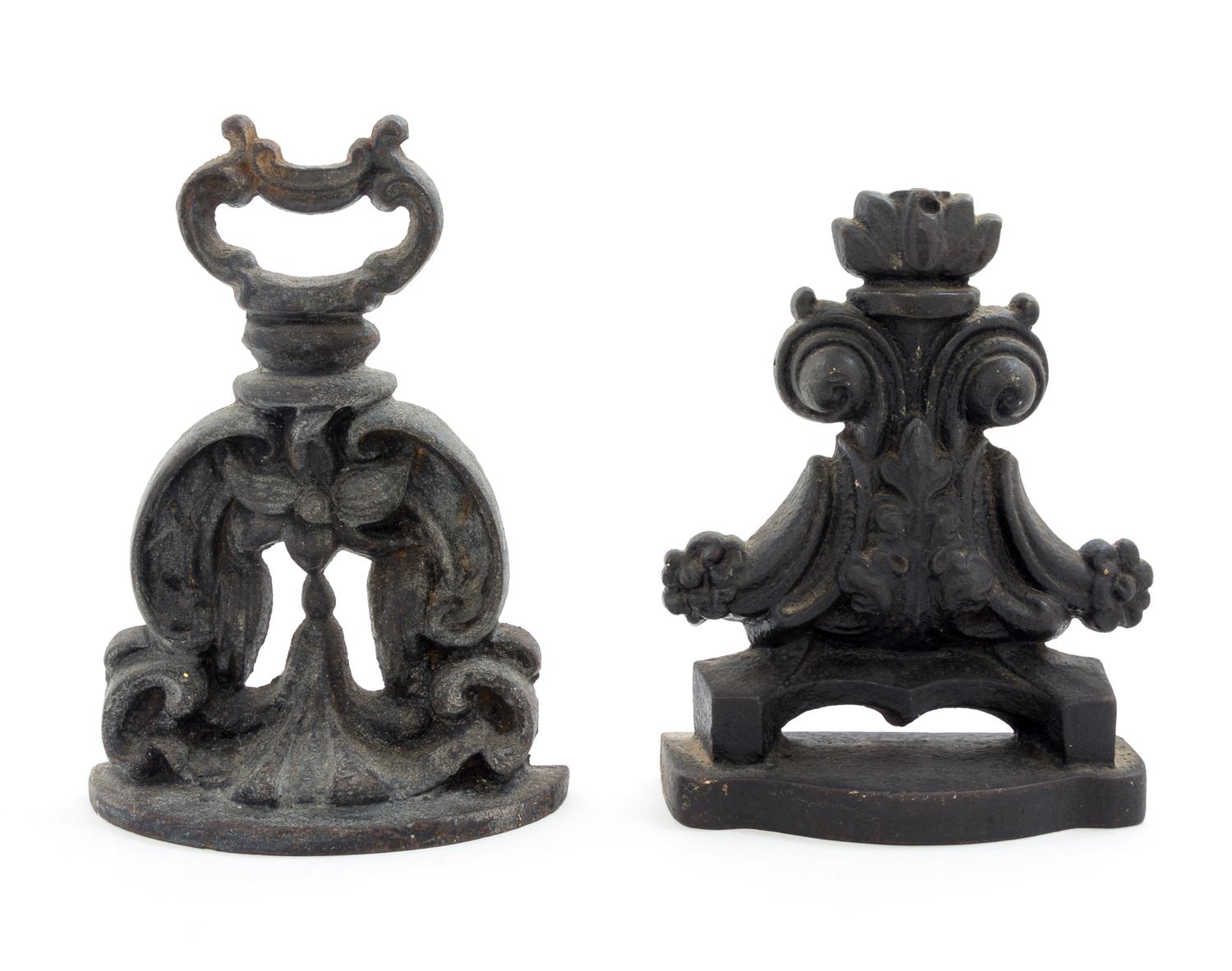 Two Cast Iron Doorstops Height of tallest 9 1/4 inches.
