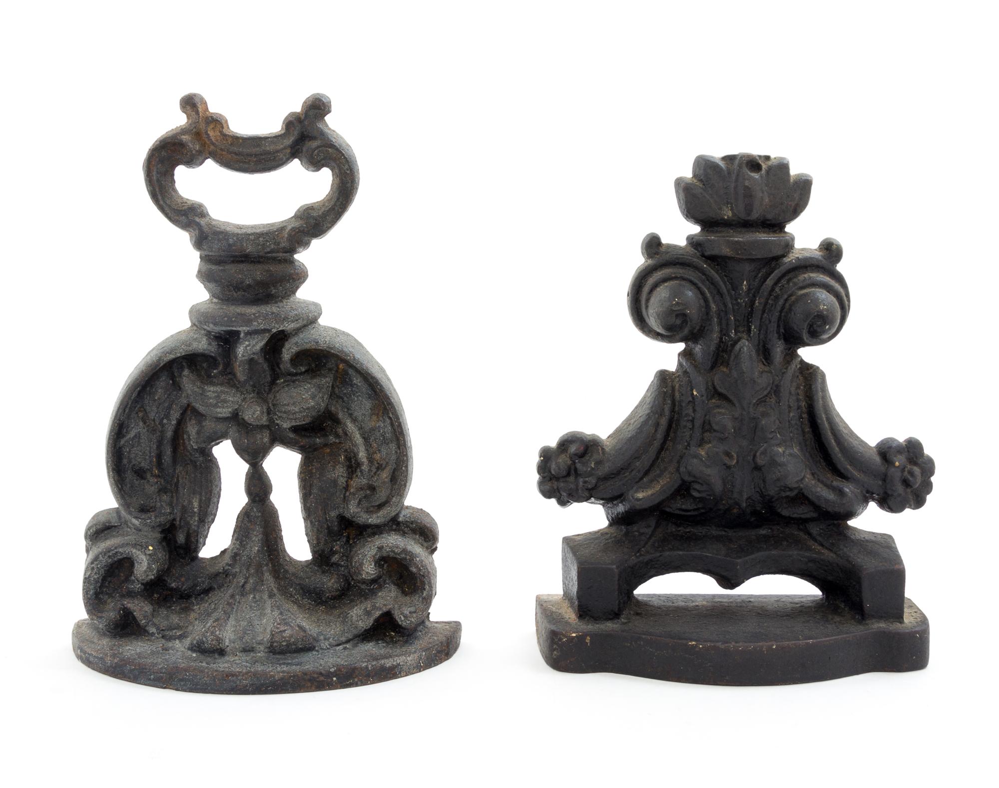 Two Cast Iron Doorstops Height of tallest 9 1/4 inches.