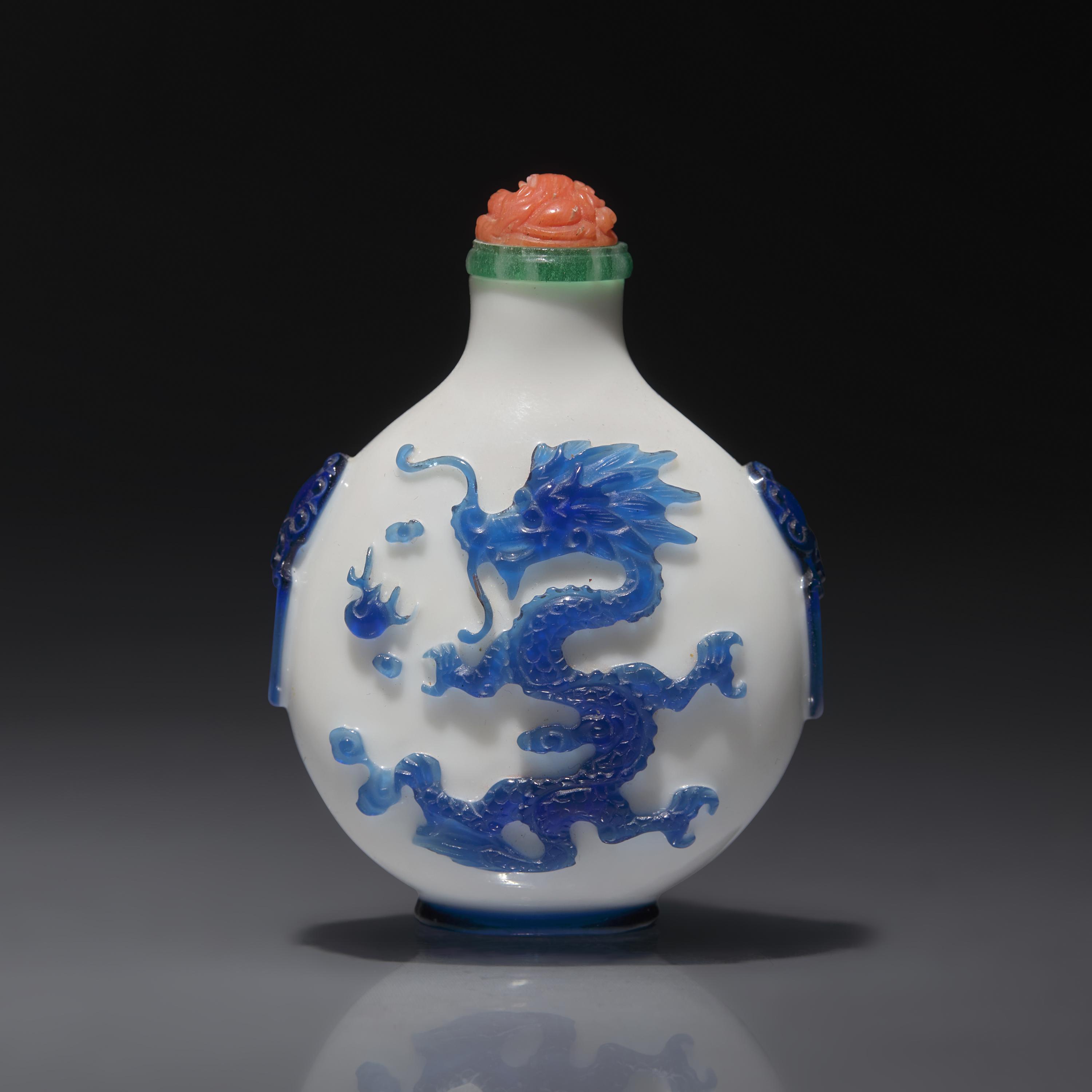 A Chinese Glass Overlay "Dragons" Snuff Bottle, Qing Dynasty, 18th/First Half 19th century — 清中期 涅白地套藍料雙龍戲珠紋鋪首啣環耳鼻煙壺
