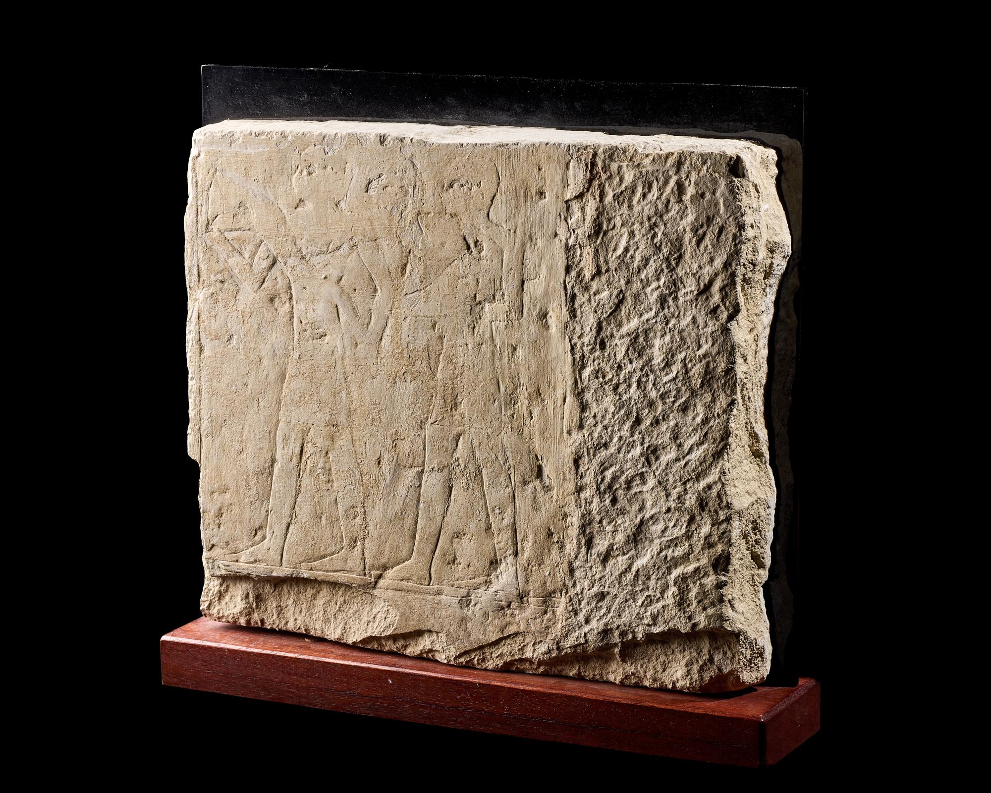 An Egyptian Limestone Relief Fragment Depicting an Offering Scene