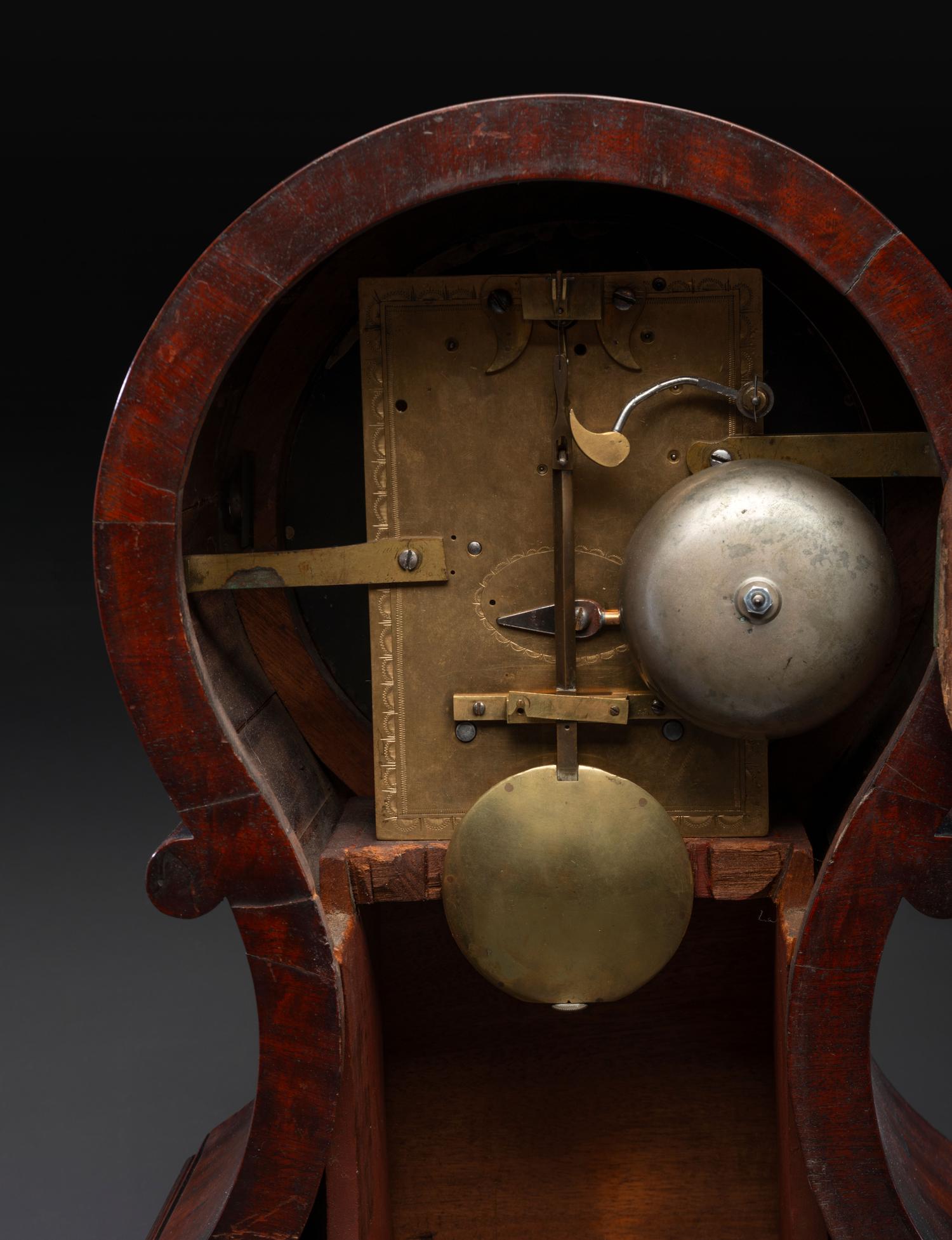A Federal Carved and Figured Mahogany Balloon-Form Bracket Clock
