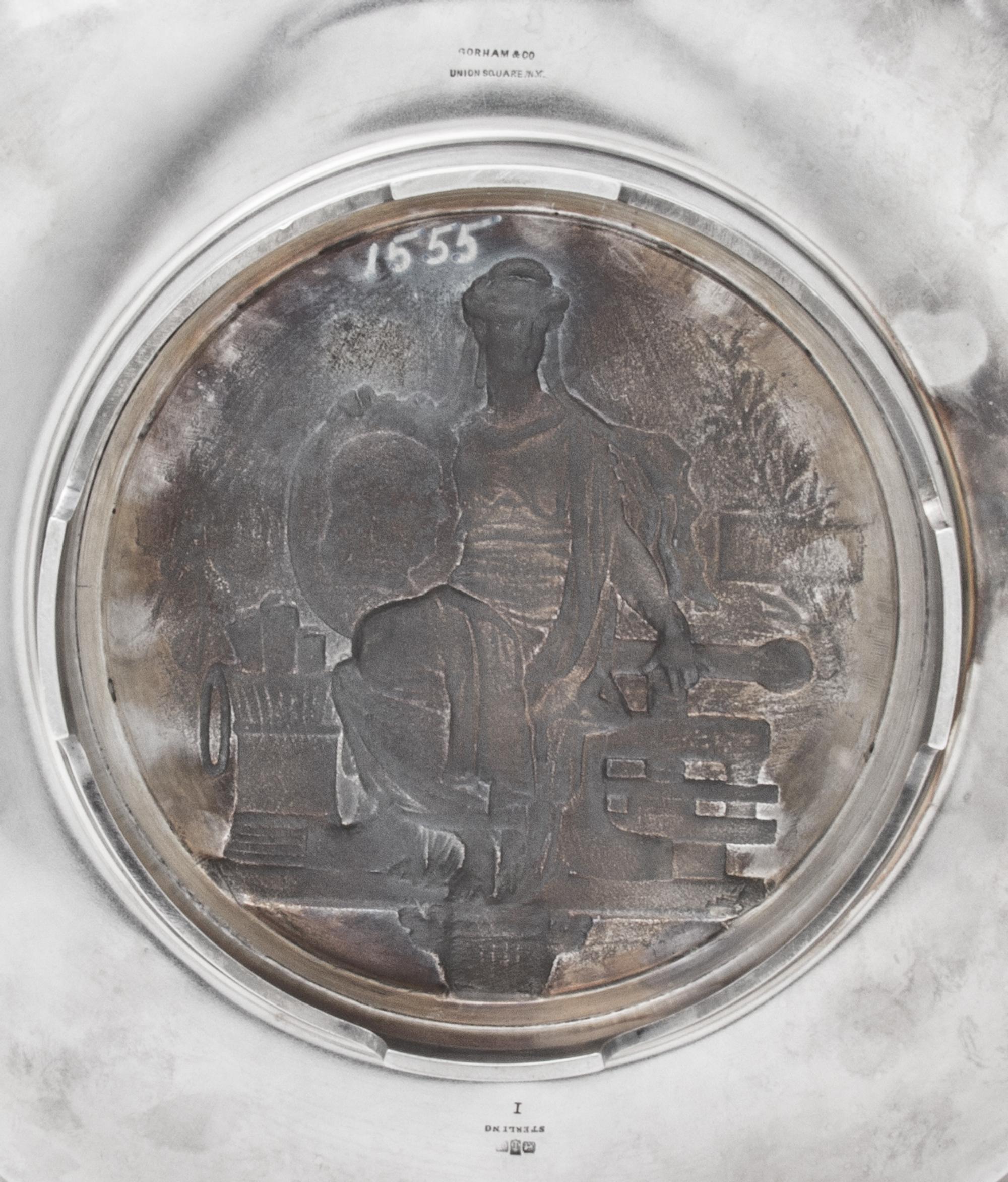 An American Silver Commemorative Dish, Gorham Mfg. Co., Providence, RI, 1876, the twin-handled circular dish centered with a medallion