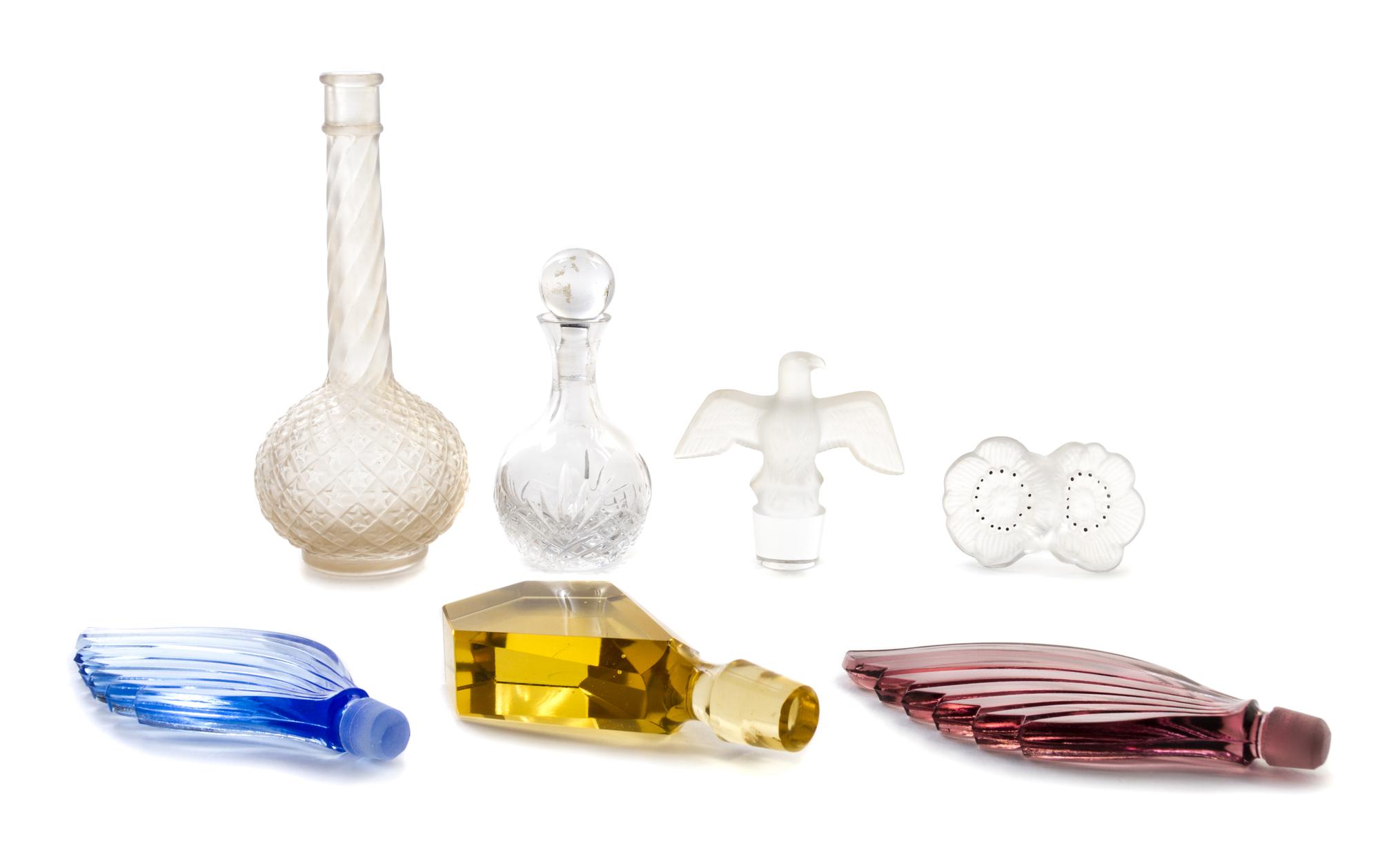 A Collection of Perfume Bottles and Stoppers Height of tallest 6 1/2 inches.