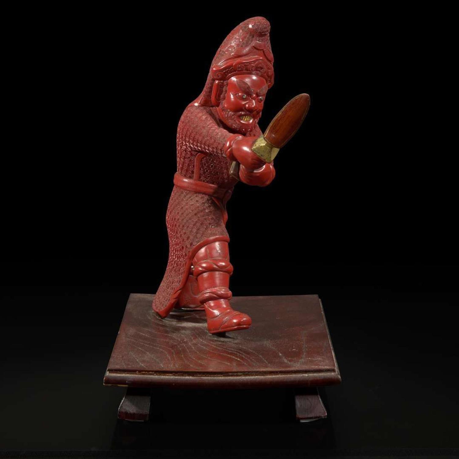 An unusual and finely-carved cinnabar lacquer figure of a warrior 朱漆武士像
