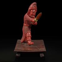 An unusual and finely-carved cinnabar lacquer figure of a warrior 朱漆武士像