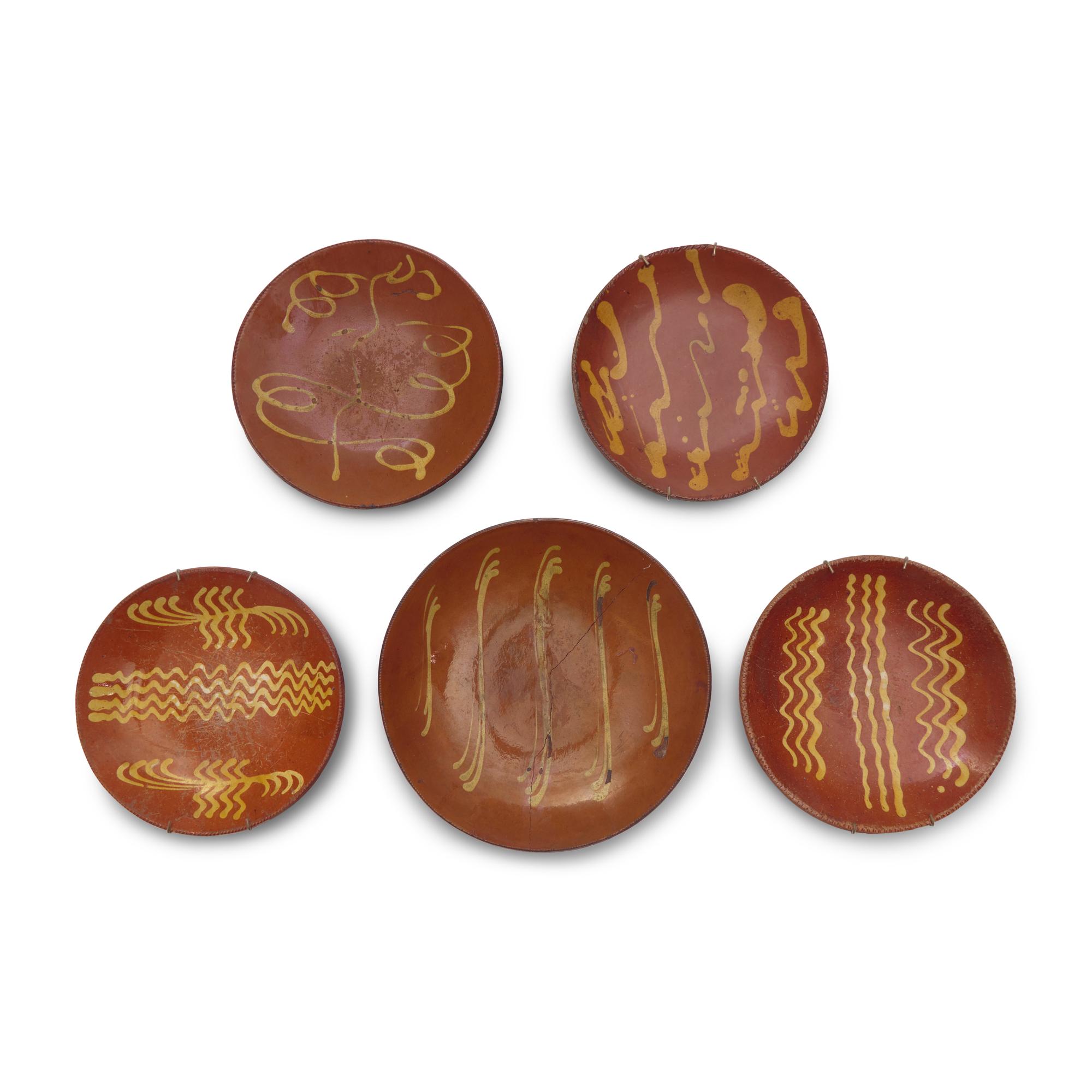 A Group of Five Slip-Decorated Redware Plates