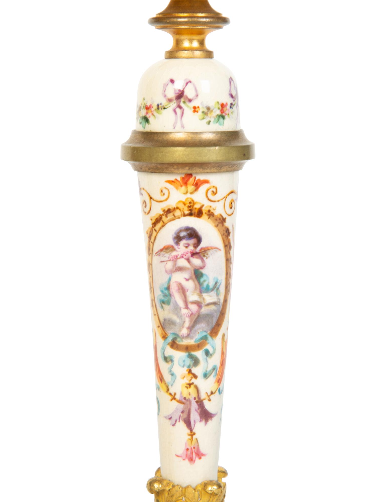 A Pair of French Gilt Bronze and Painted Porcelain Candlesticks