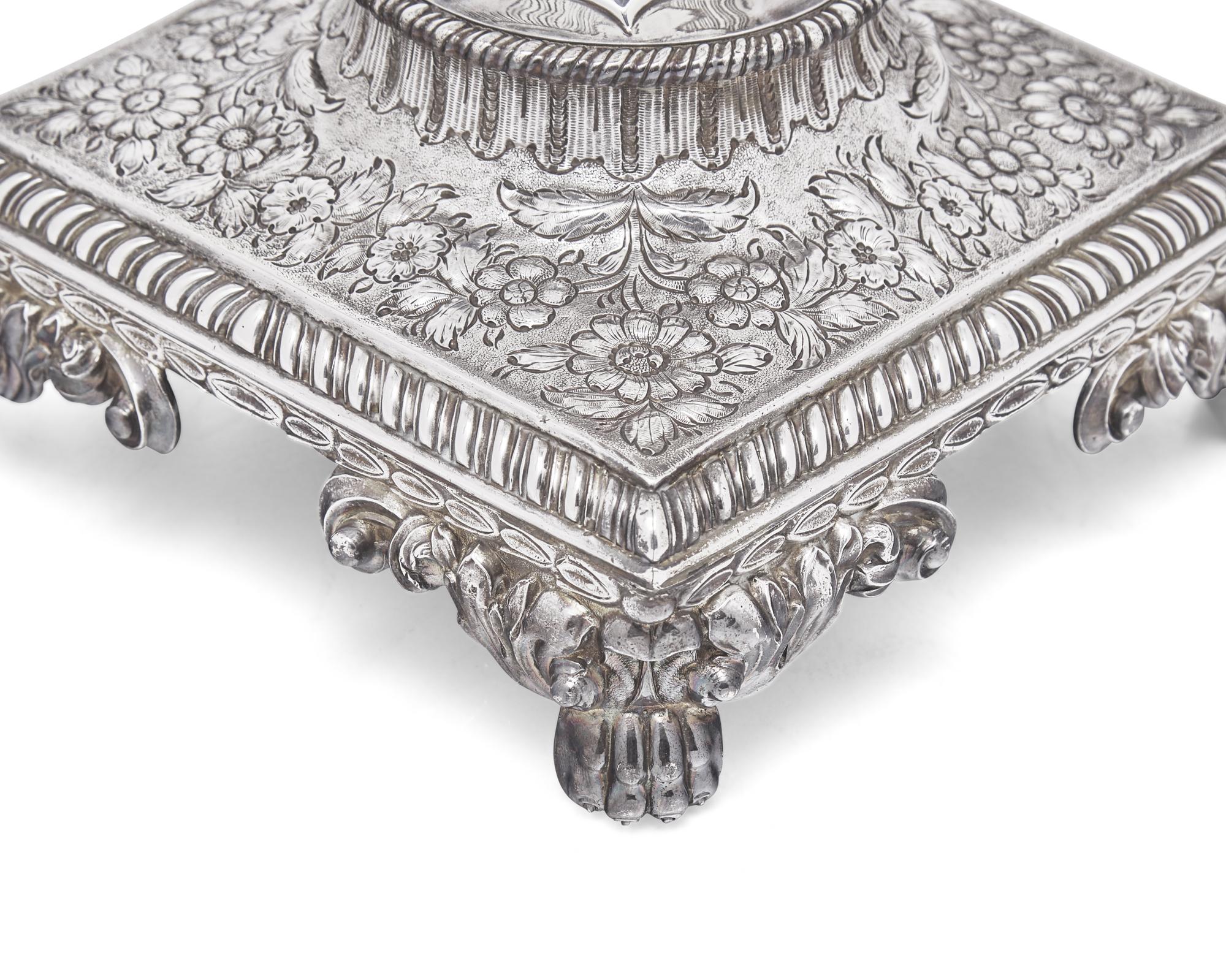 A George III sterling silver floral repoussé hot water urn, maker's mark rubbed, London, 1766