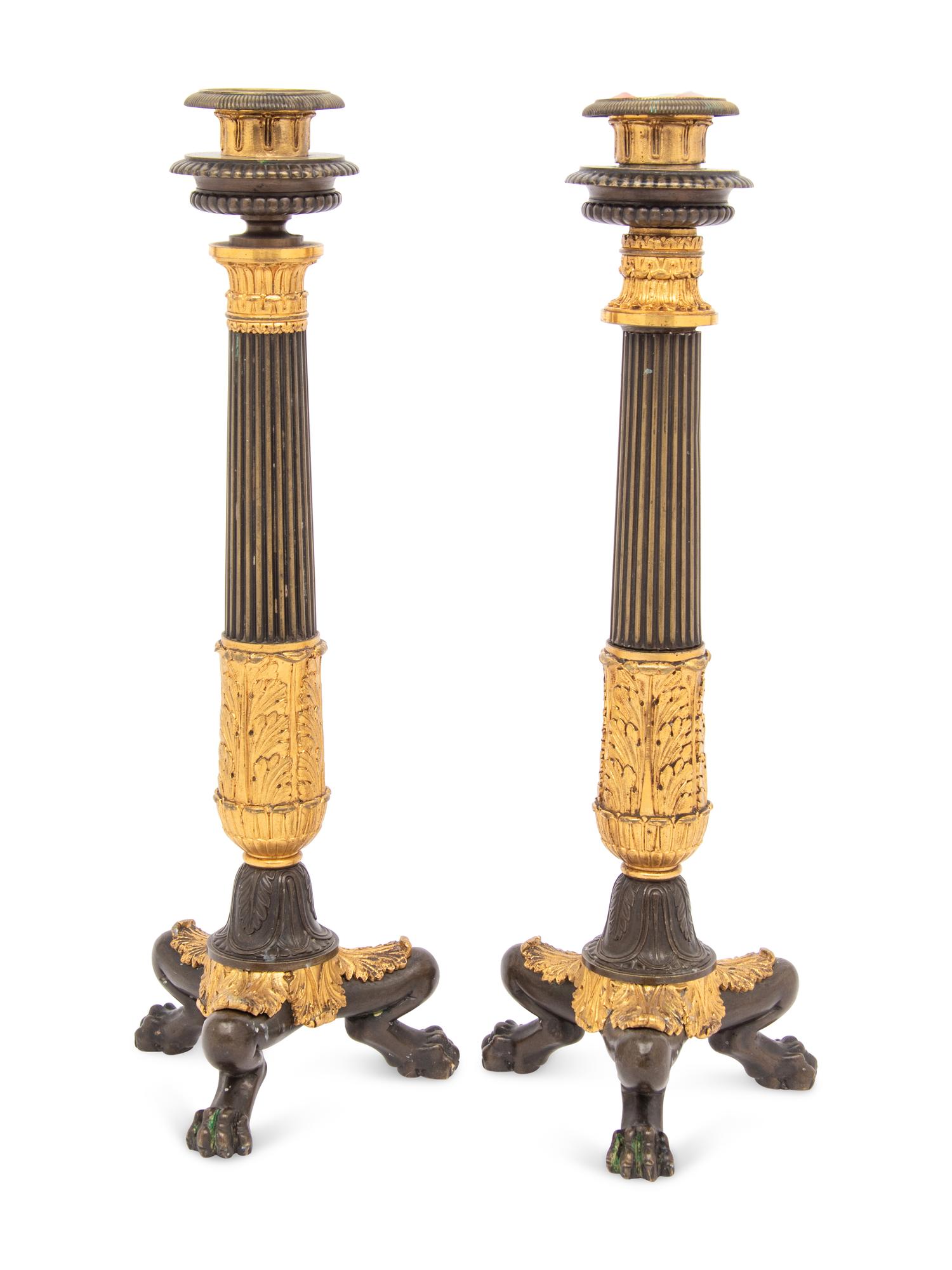A Pair of French Parcel Gilt and Patinated Bronze Candlesticks