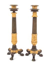 A Pair of French Parcel Gilt and Patinated Bronze Candlesticks