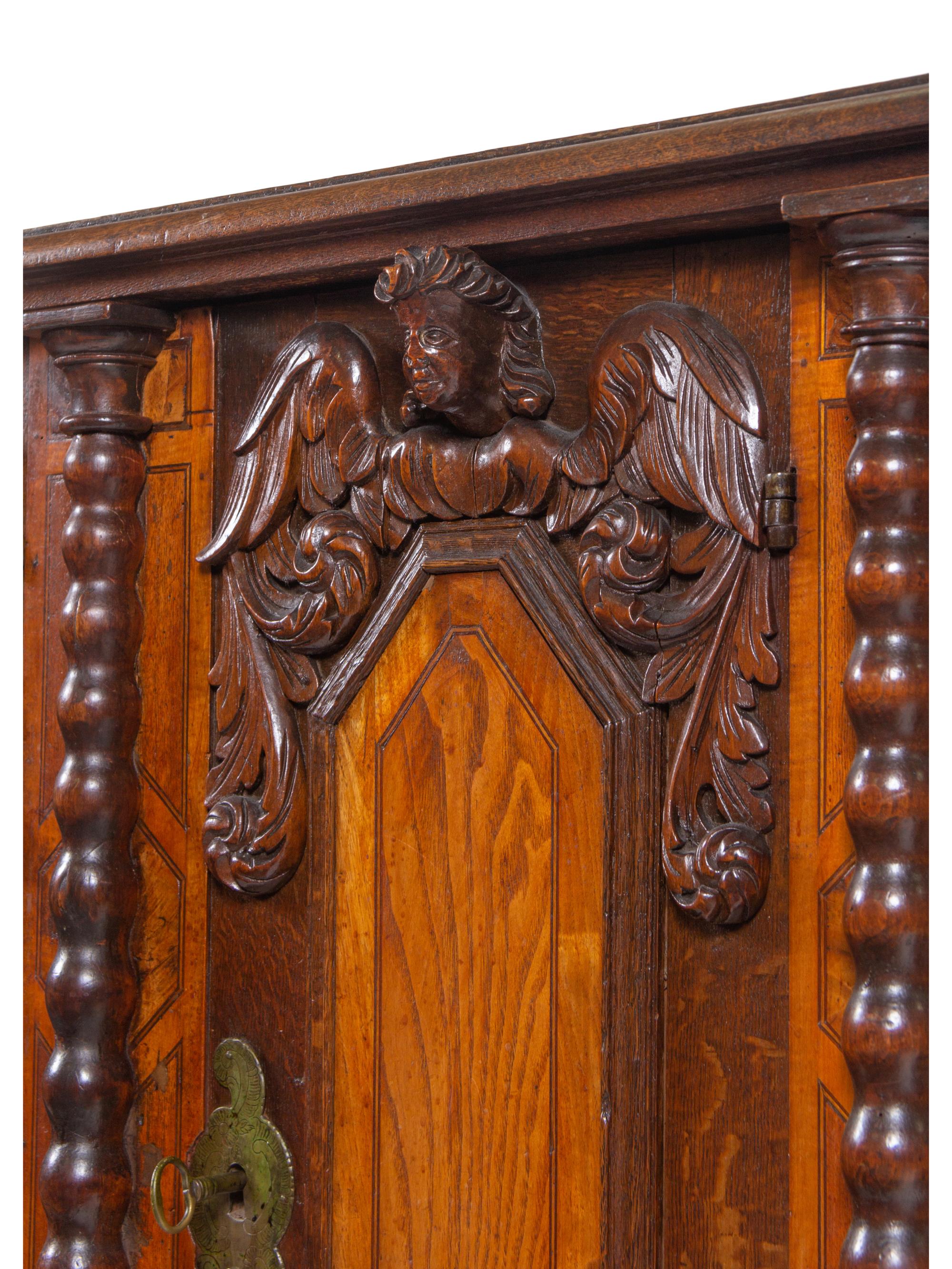 An Italian Baroque Carved Walnut and Oak Cabinet