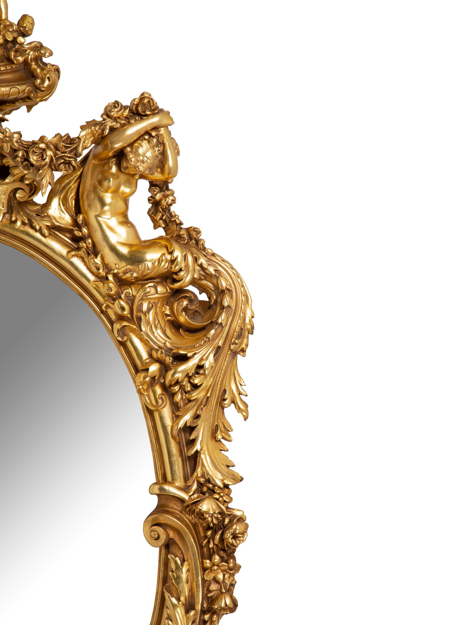A Pair of Italian Baroque Carved Giltwood Oval Mirrors — 19TH CENTURY