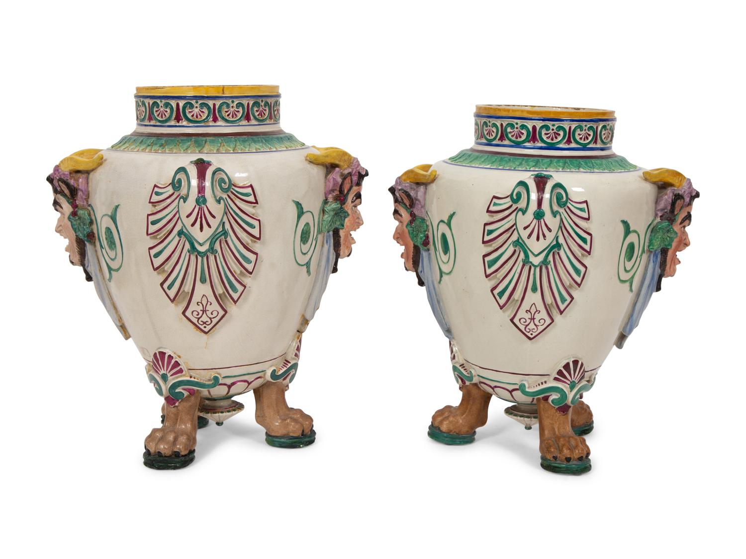 A Pair of Italian Glazed Ceramic Urns Decorated with Horned Masks and Paw Feet