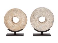Two Millstone Disks on Metal Stands