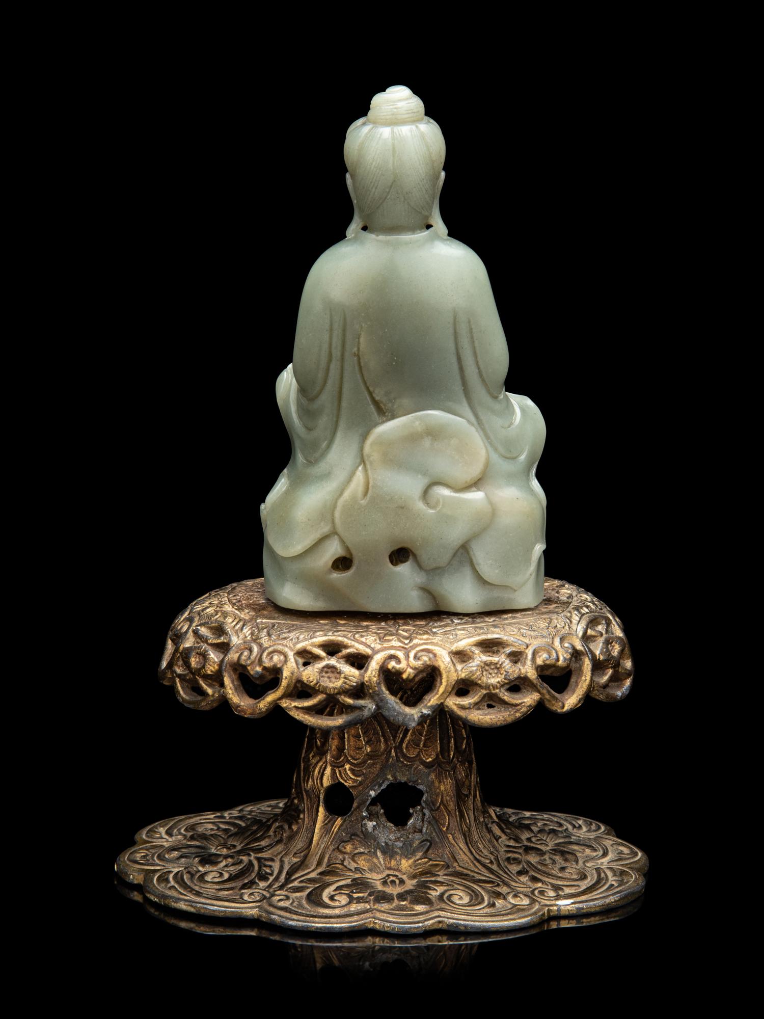 A Chinese Celadon Jade Figure of Seated Guanyin