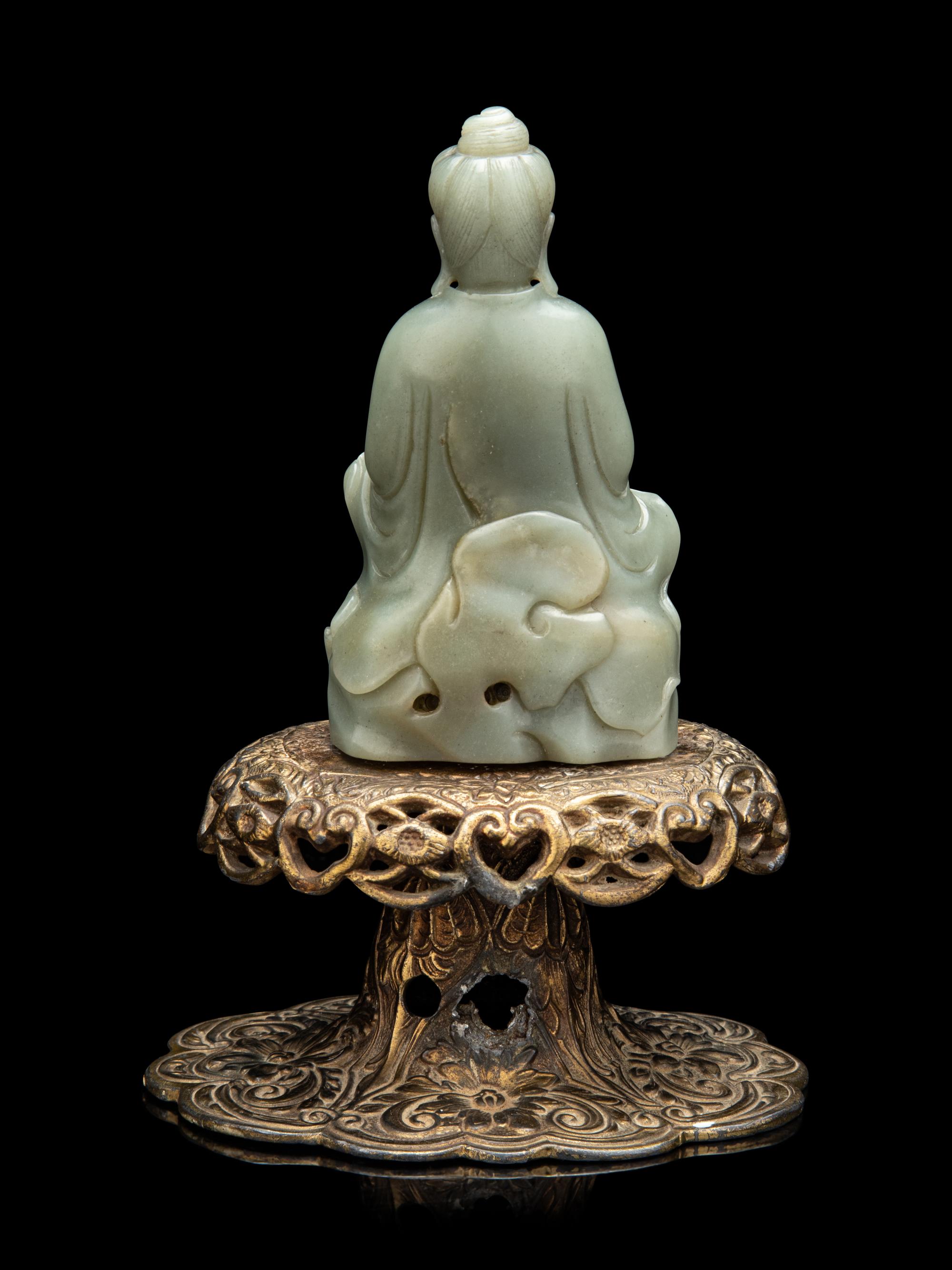 A Chinese Celadon Jade Figure of Seated Guanyin