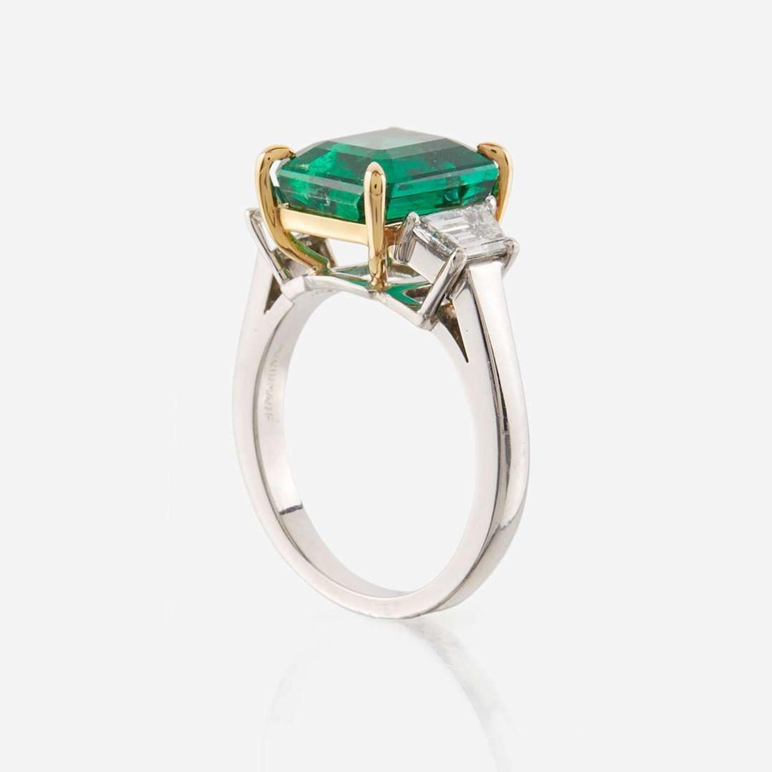 An emerald, diamond, and platinum ring