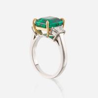 An emerald, diamond, and platinum ring