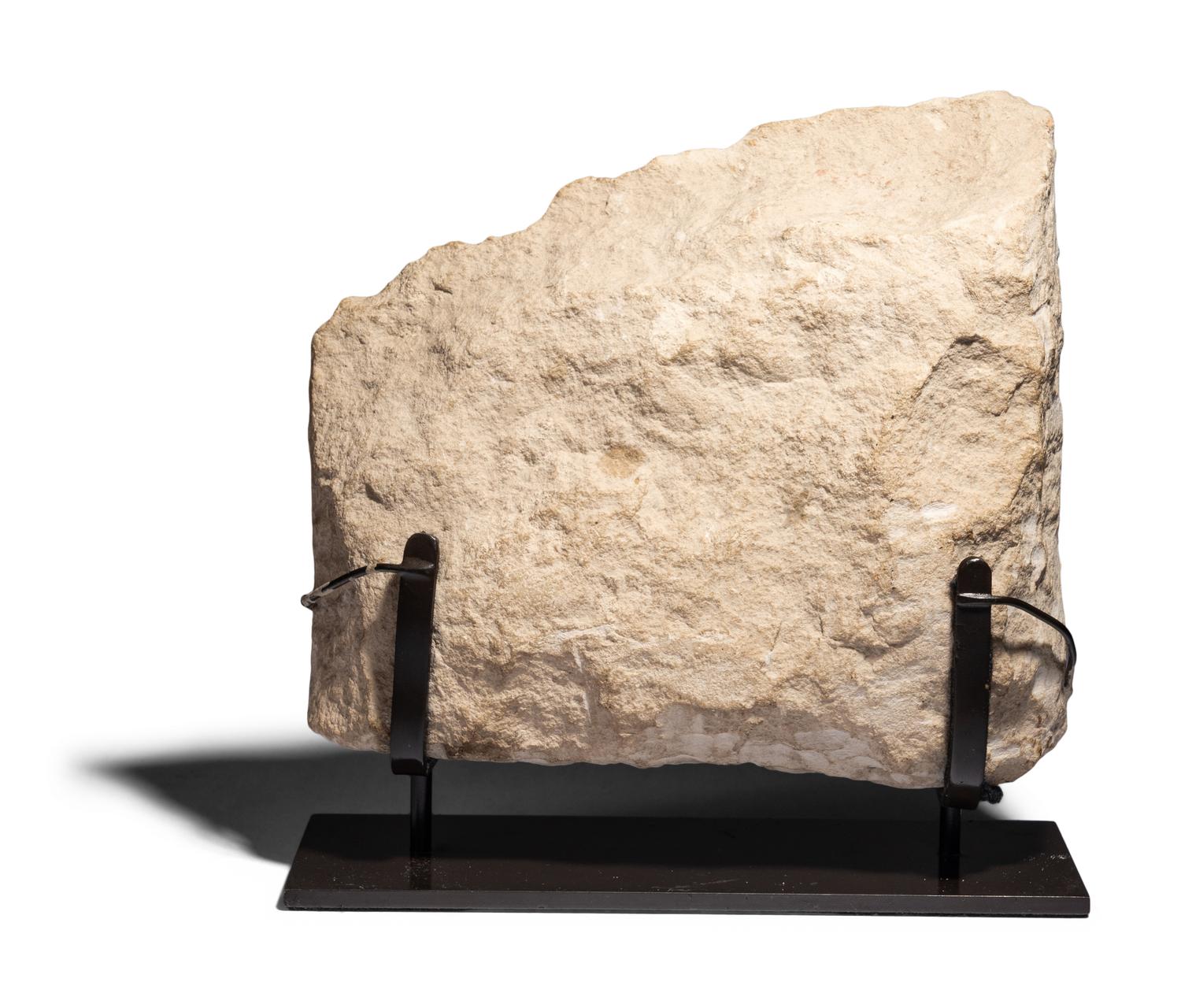 An Egyptian Limestone Relief Fragment with Serving Woman