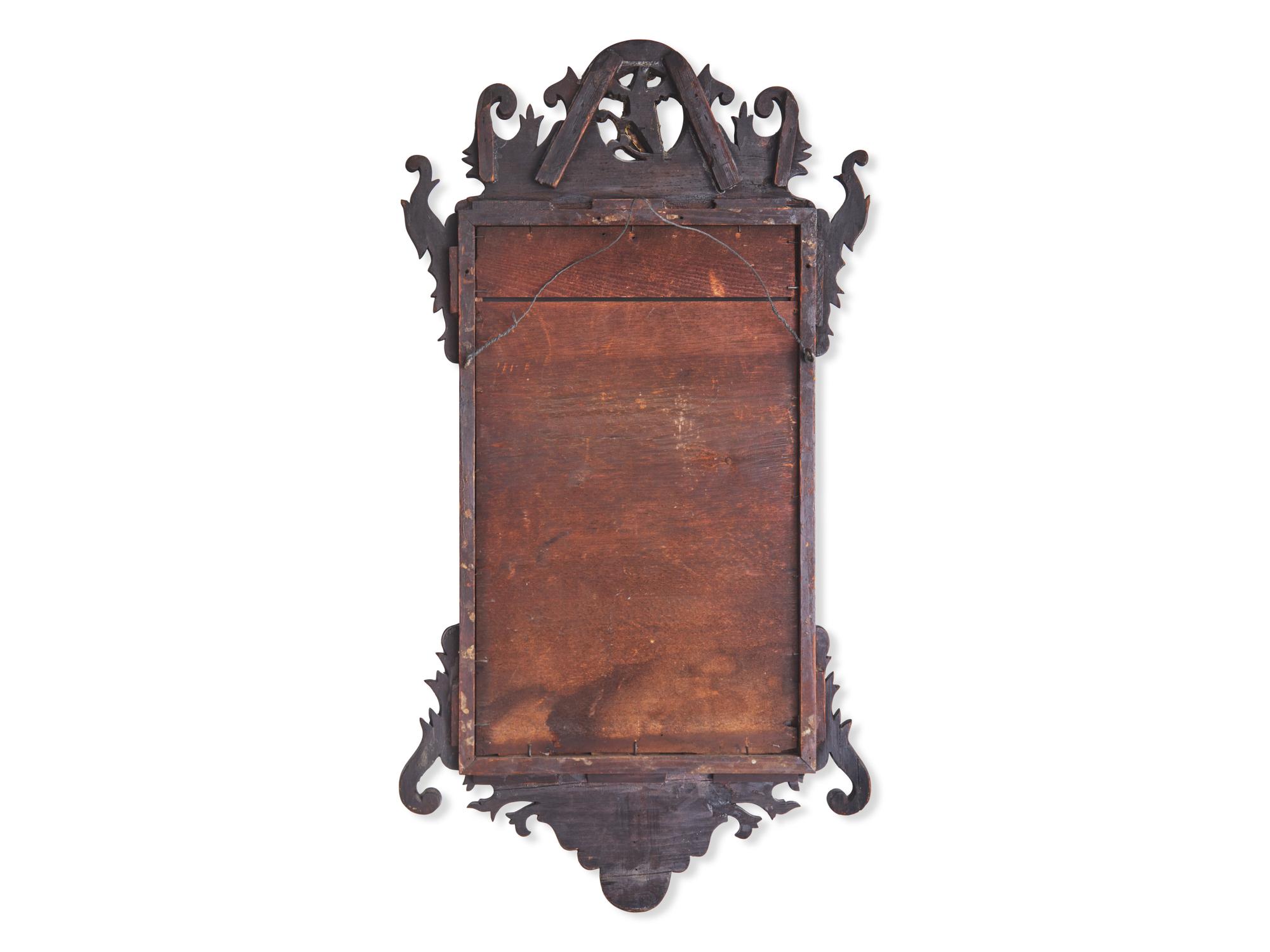 A Chippendale Fret-Carved and Parcel-Gilt Mahogany Looking Glass