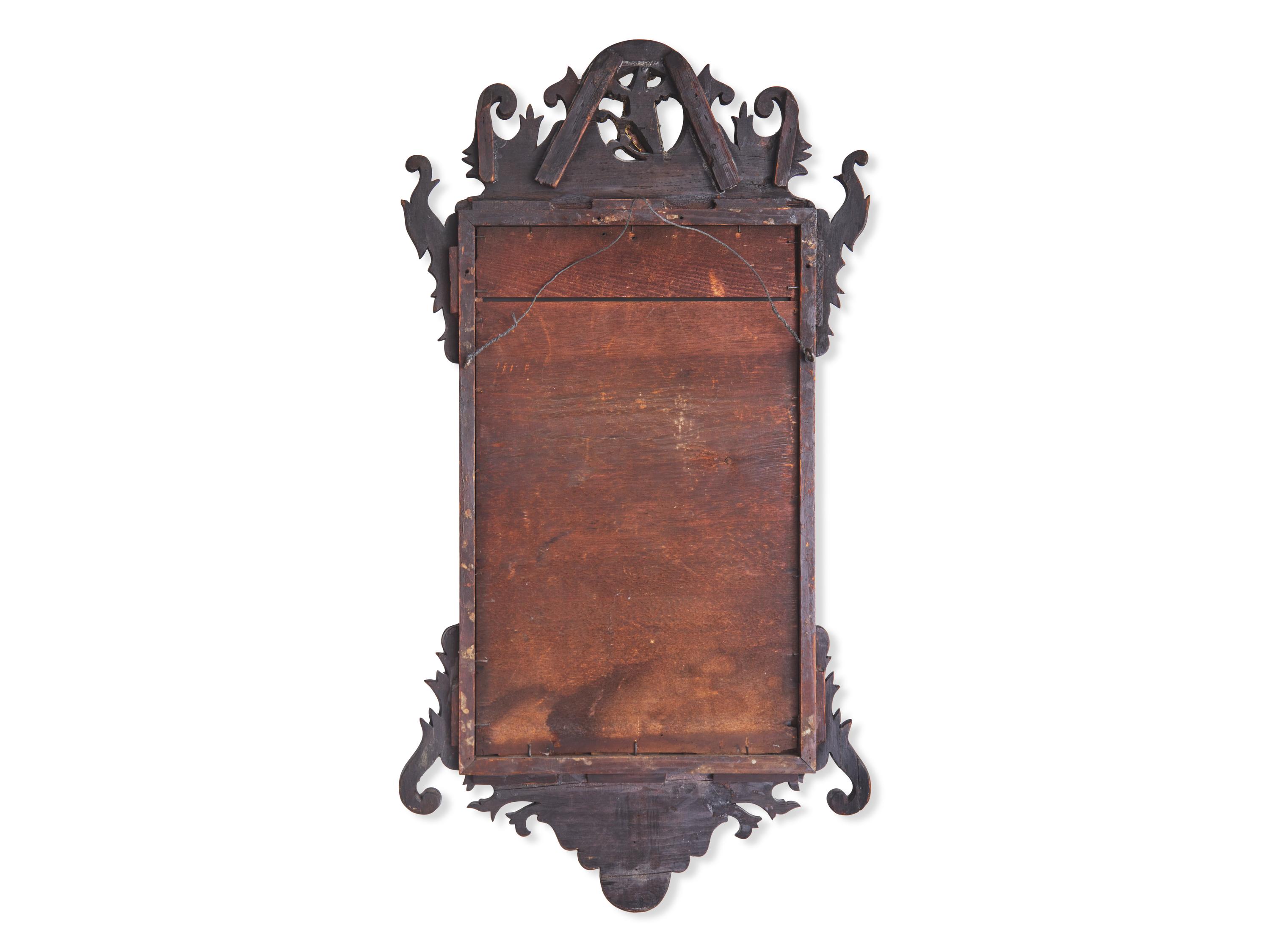 A Chippendale Fret-Carved and Parcel-Gilt Mahogany Looking Glass